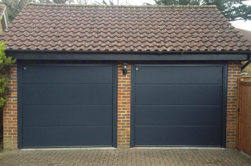 Pair of L-Ribbed Sectional Garage Doors by Teckentrup in Black